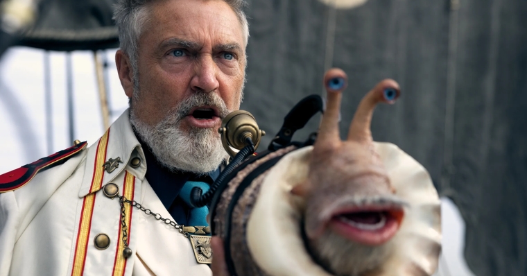 In Netflix's "One Piece," Vice-Admiral Garp of the Marines (portrayed by Vincent Regan) ingeniously employs a snail as his quirky loudspeaker.